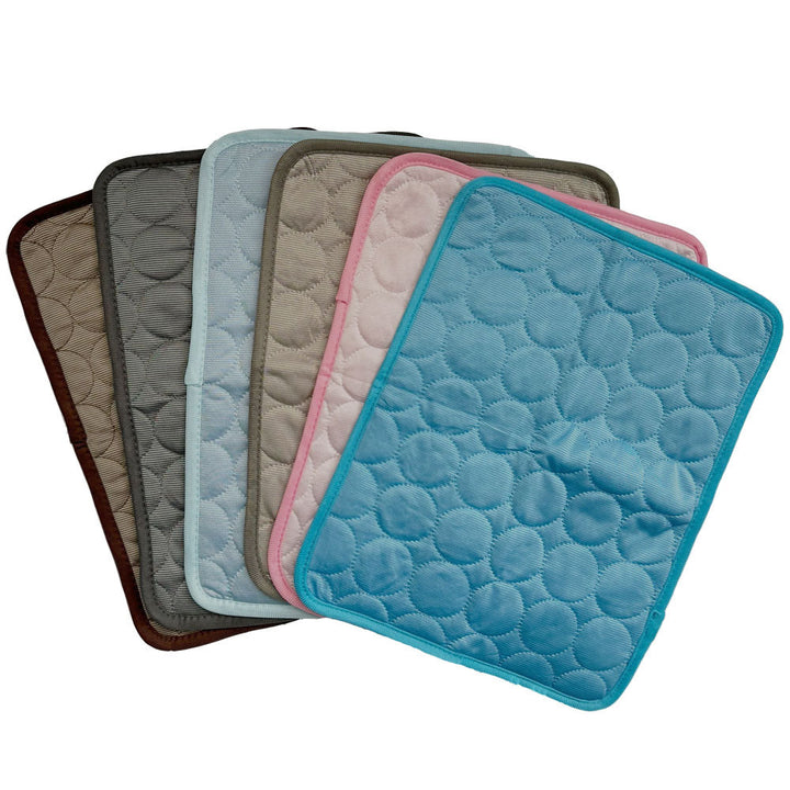 Set of five quilted mats in various colors on a white background